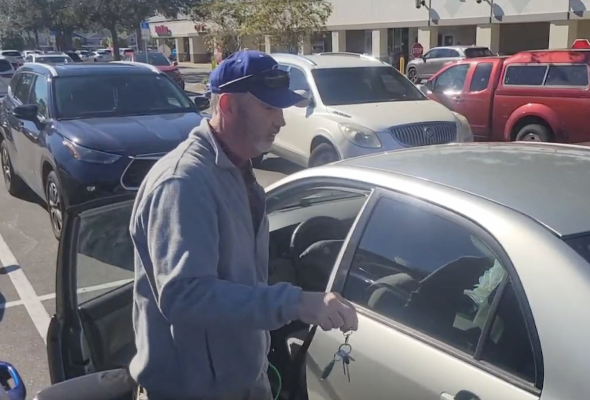 Paul working on a car to extract the lost keys.